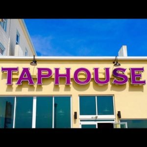 a big building with Taphouse bar and grill signs.